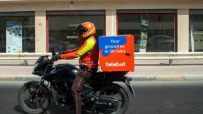 Talabat delivery rider on a motorbike delivering food in Manama, Kingdom of Bahrain, Middle East