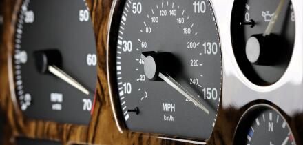 speedometer in car dashboard at full speed