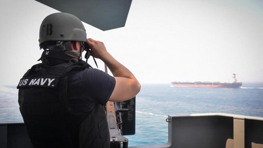 STRAIT OF HORMUZ (July 23, 2017) U.S. Navy Gunner's Mate 3rd Class Jalen Delgado, from Boston, observes passing ships aboard the aircraft carrier USS Nimitz (CVN 68), July 23, 2017, in the Strait of Hormuz. Nimitz is deployed in the U.S. 5th Fleet area of