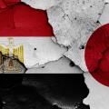 flags of Egypt and Japan painted on cracked wall