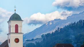 Church tower and mountains in Mauren, Liechtenstein