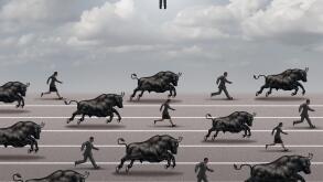 Escape the bull market and investing timing concept as an investment strategy symbol as bulls and shareholders running in an economic crisis.