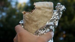 Holding Carne Asada Burrito Wrapped in Foil