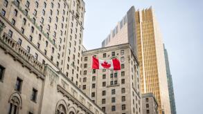 Canadian flag in front of a business building and an older skyscraper in Toronto, Ontario, Canada

Old and new buildings seen from the ground with a c