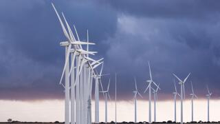 Iberdrola Wind Turbine - Eolic Generator with stormy clouds in Sisante, Cuenca province, Castilla, Spain