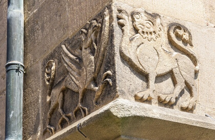 Cornerstone with heraldic mythical creatures, griffin and griffin lion, at the Collegiate Church in Tubingen, Baden-Wurttemberg, Germany.