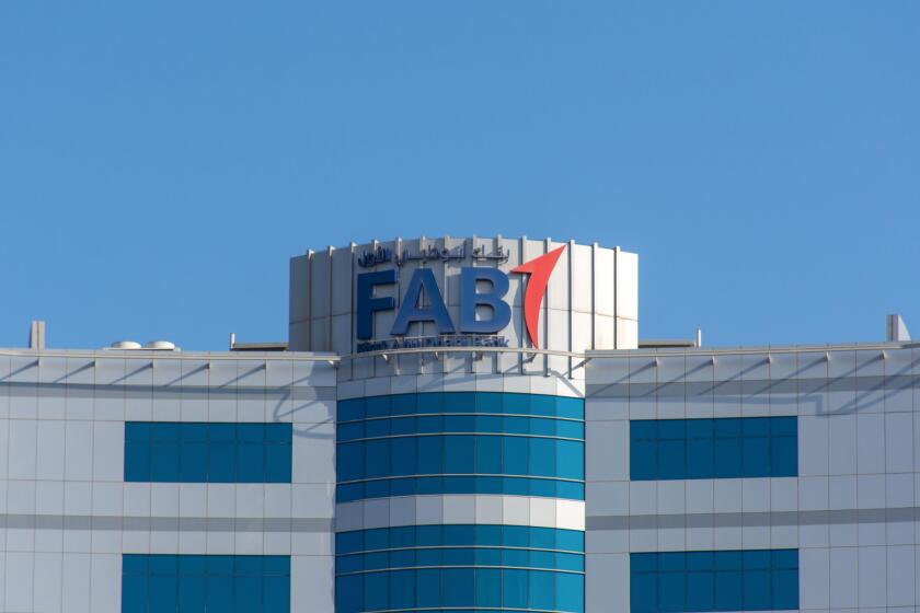 "Ras al Khaimah, Ras al Khaimah/United Arab Emirates - 10/16/2019: "First Abu Dhabi (FAB) Bank blue logo on large building top on a blue sky sunny day