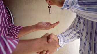 Handing over keys and shaking hands