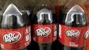 FILE - This April 28, 2016, file photo shows bottles of Dr. Pepper on a store shelf at Quality Cash Market in Concord, N.H. Keurig is buying Dr. Pepper Snapple Group Inc. to create a beverage business with approximately $11 billion in annual sales, announ