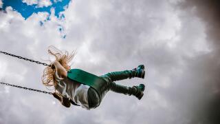 Girl on a swing on a cloudy day