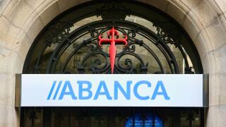 Cross of Saint James and Abanca Sign over the entrance to a bank branch in the historic city centre of Santiago de Compostela Galicia Spain