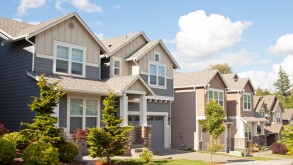 new beautiful American luxury houses at sunny day with green grass