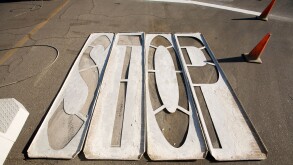 Wood stencils for painting STOP on pavement laying on asphalt street with orange traffic cones Indio California USA. Image shot 2009. Exact date unknown.