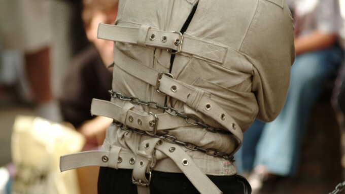 straight jacket street entertainer mad looney mental health handcuff tied up chain lock locked key strap escapologist escape jai