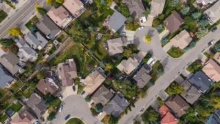 Aerial top down view of houses and streets in beautiful residential neighbourhood during fall season in Calgary, Alberta, Canada.