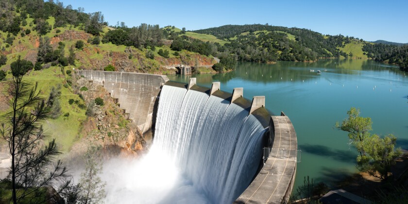 Water spills over the top of Englebright Dam on the Yuba River. 