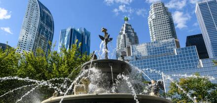 Berczy Park Dog Fountain and surrounding urban skyline cityscape of downtown Toronto, Ontario, Canada.