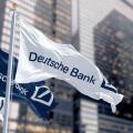 Berlin, DE, March 2023: Flags of Deutsche Bank waving in the wind in a financial district. On march 2023 Deutsche Bank suffered a stock market crash.