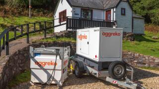 Aggreko Mobile diesel electricity generator on site in a remote countryside location.