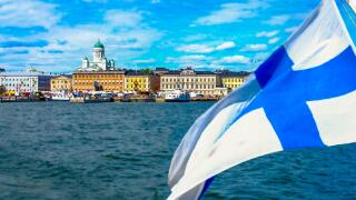 Helsinki skyline from the sea.The Finnish flag is floating. Market Square and Helsinki Cathedral from the sea. The seascape of Helsinki in the summer.