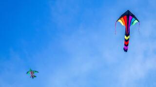 Two colourful kites flying high on sunny day, Brenton Point State Park, Newport, Rhode Island, USA