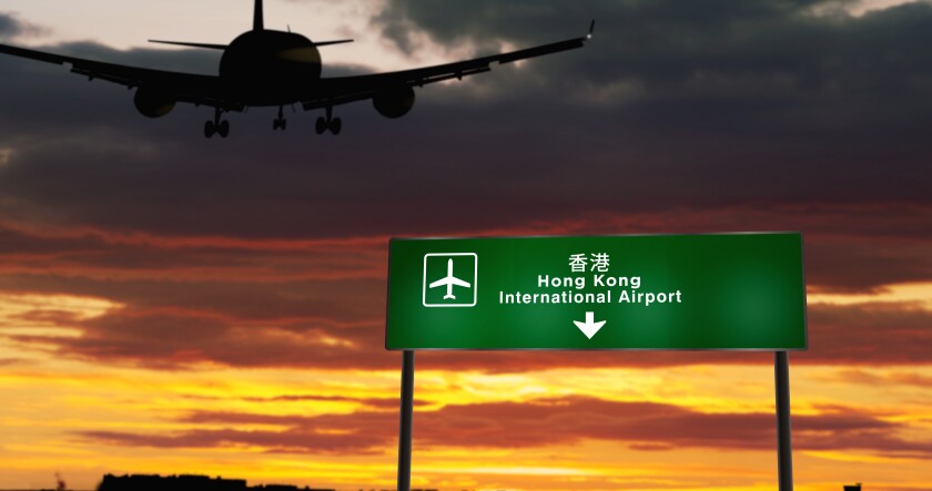 Plane landing in Hong Kong with signboard-adobe-2022Jan