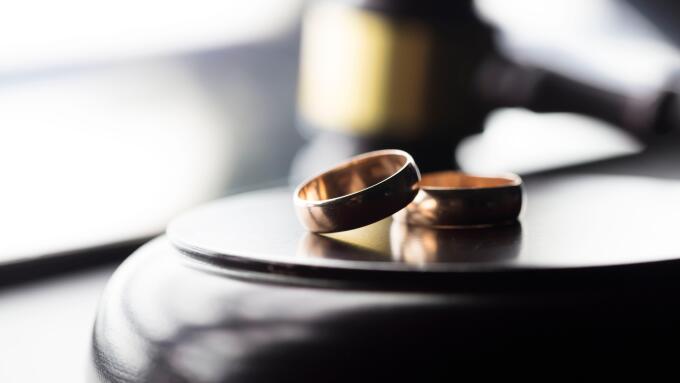 Divorce law concept. Wedding ring and gavel.