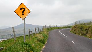Yellow road sign with question mark