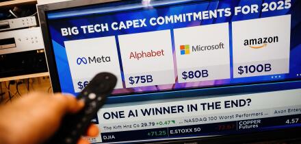 Paris, France - Feb 19, 2025: A person holds a remote while watching CNBC on a Panasonic TV, displaying Meta, Alphabet, Microsoft, and Amazon 2025 cap