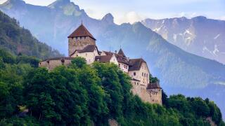 Vaduz Castle, the official residence of the Prince of Liechtenstein, with Alps mountains in background
