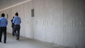 People walk by the World Bank headquarters in Washington, D.C., as seen on August 5, 2019. (Graeme Sloan/Sipa USA)