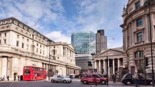 A street scene in Threadneedle Street, London, England, with the Bank of England on the left. The glass building is the...