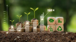 Concept of green business, finance and sustainability investment in 2024. Stack of silver coins the seedlings are growing on top with arrow of growth and icons.Carbon credit. ESG, Co2, NetZero.