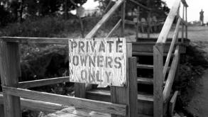 Private Owners Only hand painted sign at entrance to wooden steps and private property in East Hampton, NY.
