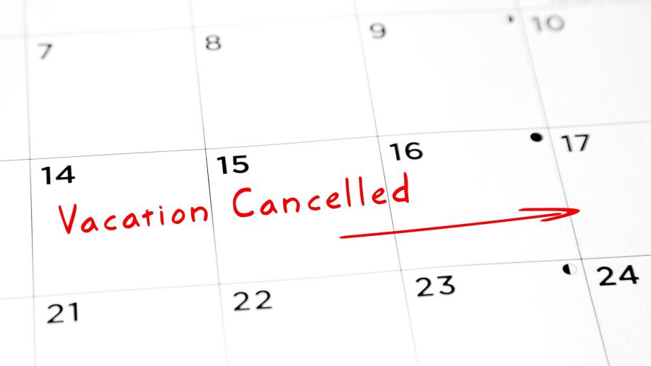 Vacation cancelled written in red marker on a calendar.