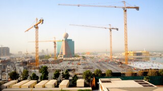 Workmen toil away in the heat constructing a shopping mall in Ras Al Khaimah in the United Arab Emirates