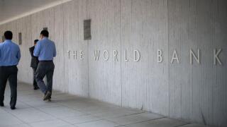 People walk by the World Bank headquarters in Washington, D.C., as seen on August 5, 2019. (Graeme Sloan/Sipa USA)