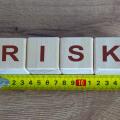 Risk Word On Blocks Arranged Behind The Ruler On Wooden Table