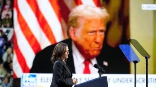 Democratic presidential nominee Vice President Kamala Harris speaks as an image of Republican presidential nominee former President Donald Trump appears on screen during a campaign rally at Erie Insurance Arena, in Erie, Pa., Monday, Oct. 14, 2024. (AP Ph