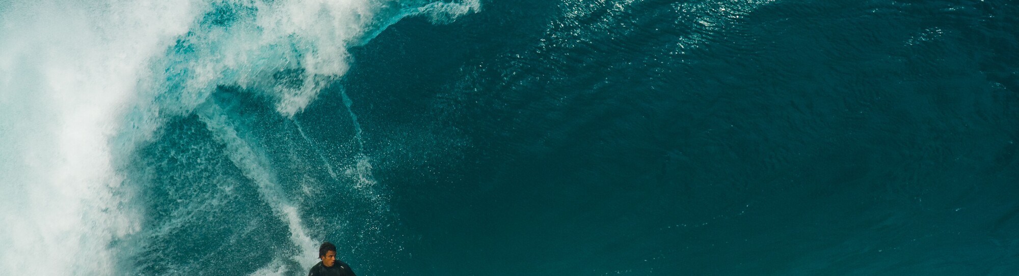 Surfer riding huge wave, Bonzai Pipeline, North Shore, Oahu, Hawaii