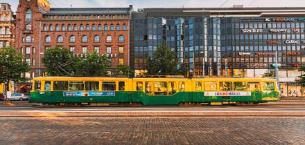 Tram departs from a stop on street Aleksanterinkatu in Helsinki