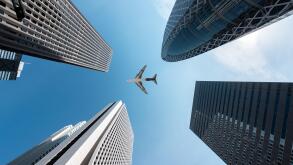 Tokyo skyscrapers buildings and a plane flying overhead at in Tokyo Shinjuku downtown and business district in morning at Tokyo, Japan.