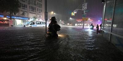 New York City, USA. 01st Sep, 2021. Members of the FDNY wade through waist high water caused by flash flooding brought by the remnants of hurricane Ida, in the New York City borough of Queens, NY, September 1, 2021. More than three inches of rain fell per