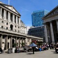 People eating lunch outside The Bank of England and The Royal Exchange, Threadneedle Street, London, England, UK