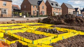 Newbuild houses on new estate with footings marked out for new house, Llanfoist, Abergavenny, UK