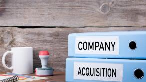 Company and Acquisition. Two binders on desk in the office. Business background