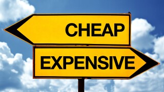 Cheap or expensive, opposite signs. Two opposite signs against blue sky background.