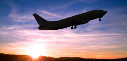 Airplane Taking Off into a Sunset.