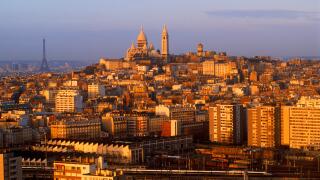 Sacre-Coeur and Eiffel Tower above Paris skyline at sunrise