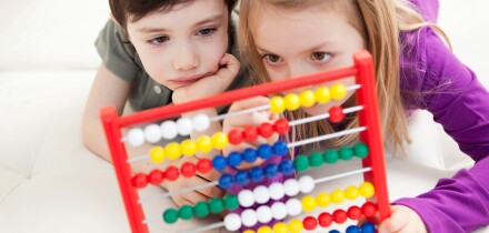 brother and sister playing with abacus
